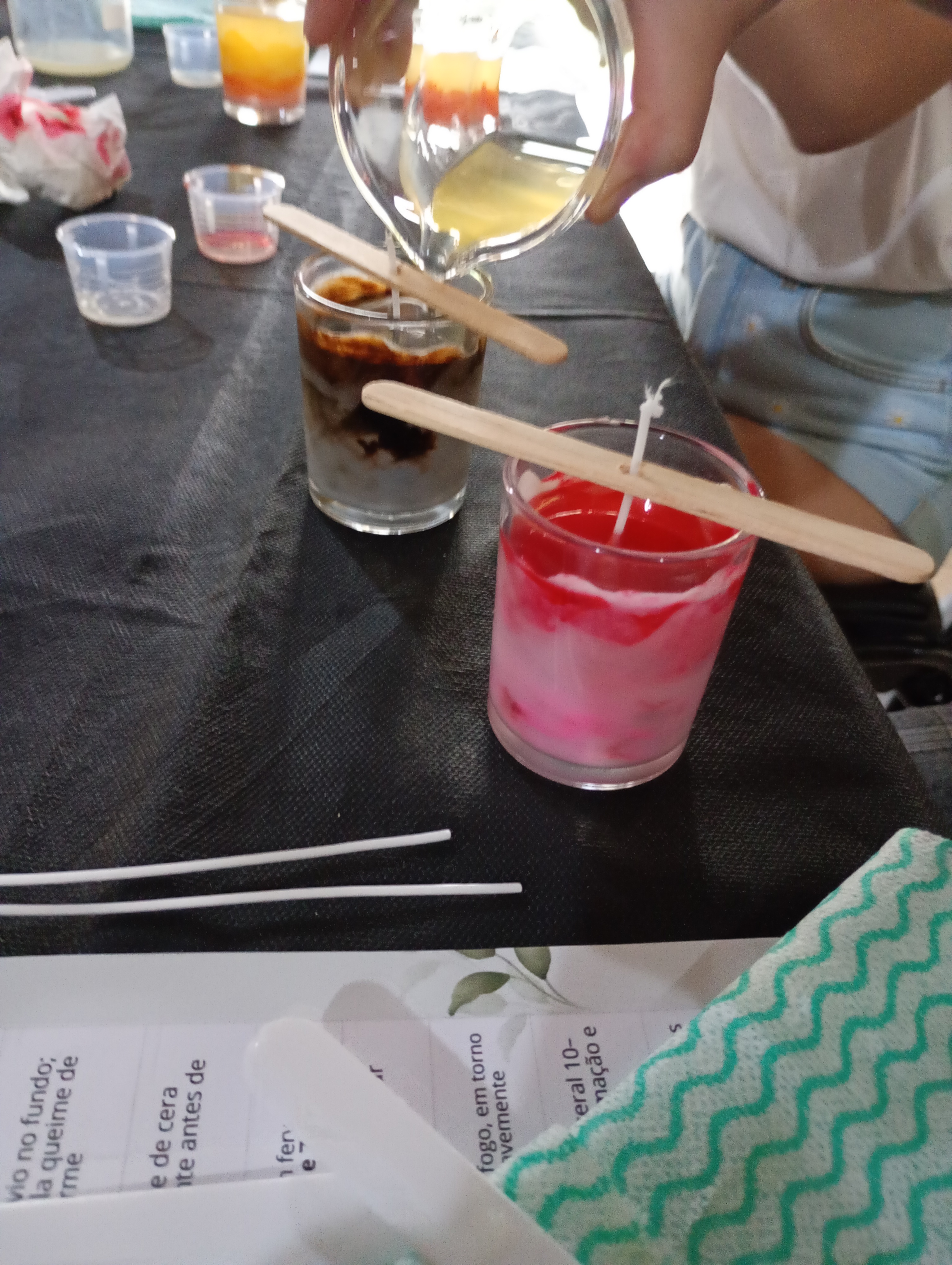 Mulheres rindo e compartilhando suas criações durante oficina de crochê do Respiro Criativo, ambiente acolhedor com novelos coloridos e xícaras de chá sobre a mesa